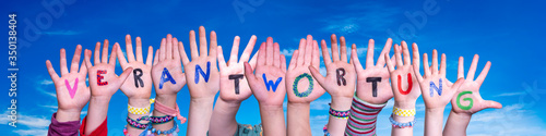 Children Hands Building Colorful German Word Verantwortung Means Resposibility. Blue Sky As Background