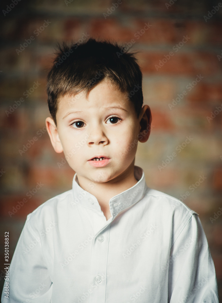 portrait of a boy with bewilderment on his face portrait of a boy with bewilderment on his face