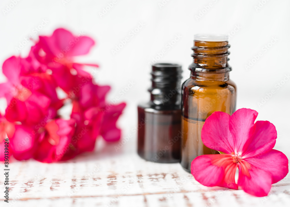 Geranium oil in glass dark bottles. Pelargonium oil. Aromatherapy Geranium oil in glass dark bottles. Pelargonium oil. Aromatherapy