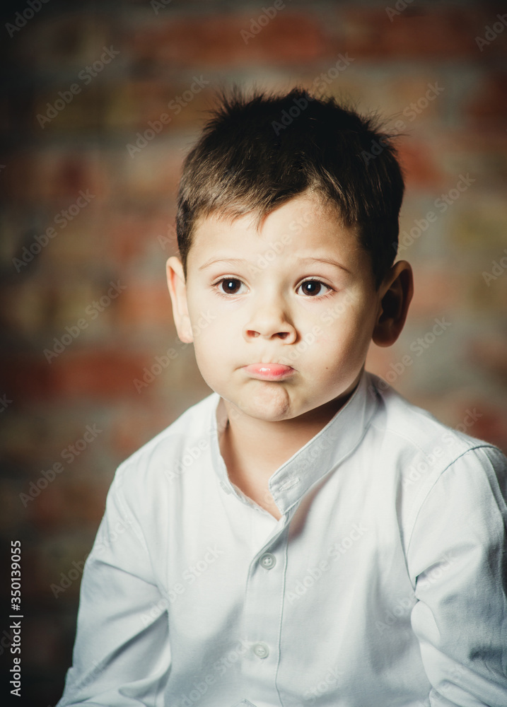 offended child on a brick background closeup portrait offended child on a brick background closeup portrait