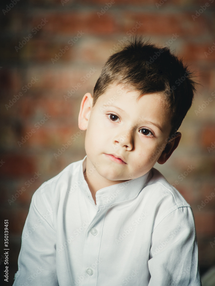 tired boy on brick wall background tired boy on brick wall background
