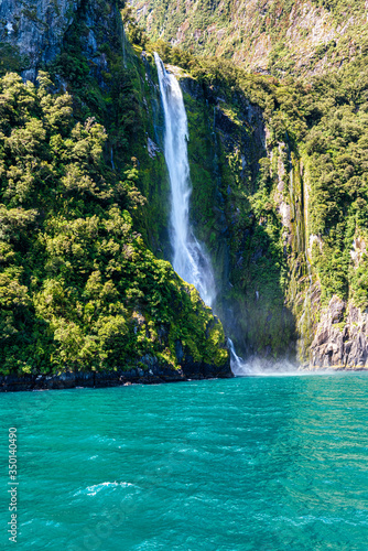 Waterfall in Milford Sound s fiord land in the south island of New Zealand.