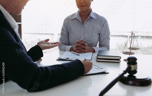Lawyer is explaining about the wrongdoing laws regarding fraud to the client at the office.