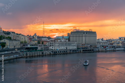 Stunning, amazing, beautiful sunset in the city, panorama of the historical region in Kyiv, Dnipro river