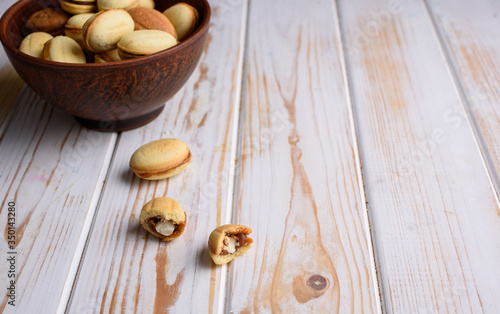 Homemade Russian nuts with condensed milk on a light background, wafer napkin. Cut nuts with condensed milk. Condensed Nuts