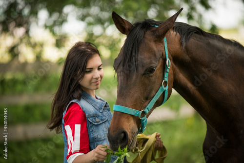 portrait of a girl with a beautiful horse in nature