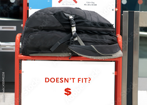 Canvas Print The large backpack lying on a control cage for measure size of carry on luggage
