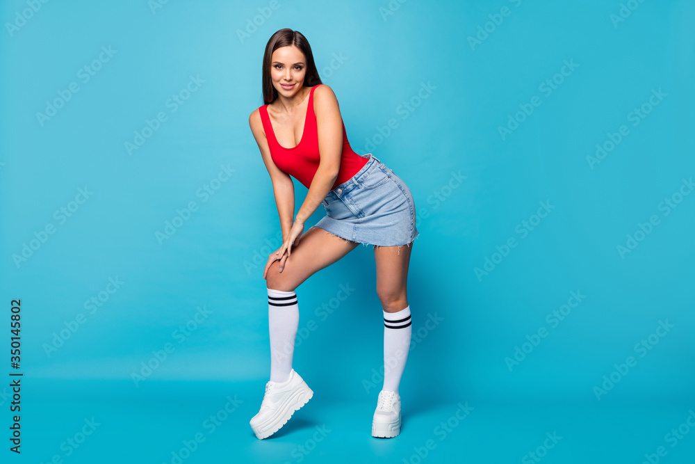 Full length photo of charming attractive fancy lady enjoy spring free time walk photographing posing touch hands legs wear tank-top shoes isolated over blue color background Full length photo of charming attractive fancy lady enjoy spring free time walk photographing posing touch hands legs wear tank-top shoes isolated over blue color background