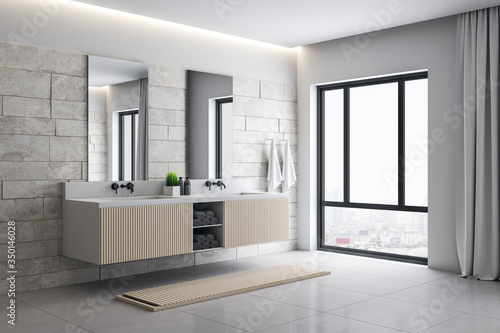 Modern loft bathroom interior with mirror and comfortable bathtub.