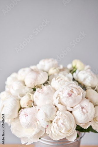 White Odile peonies in a metal vase. Beautiful peony flower for catalog or online store. Floral shop concept . Beautiful fresh cut bouquet. Flowers delivery. Copy space © malkovkosta