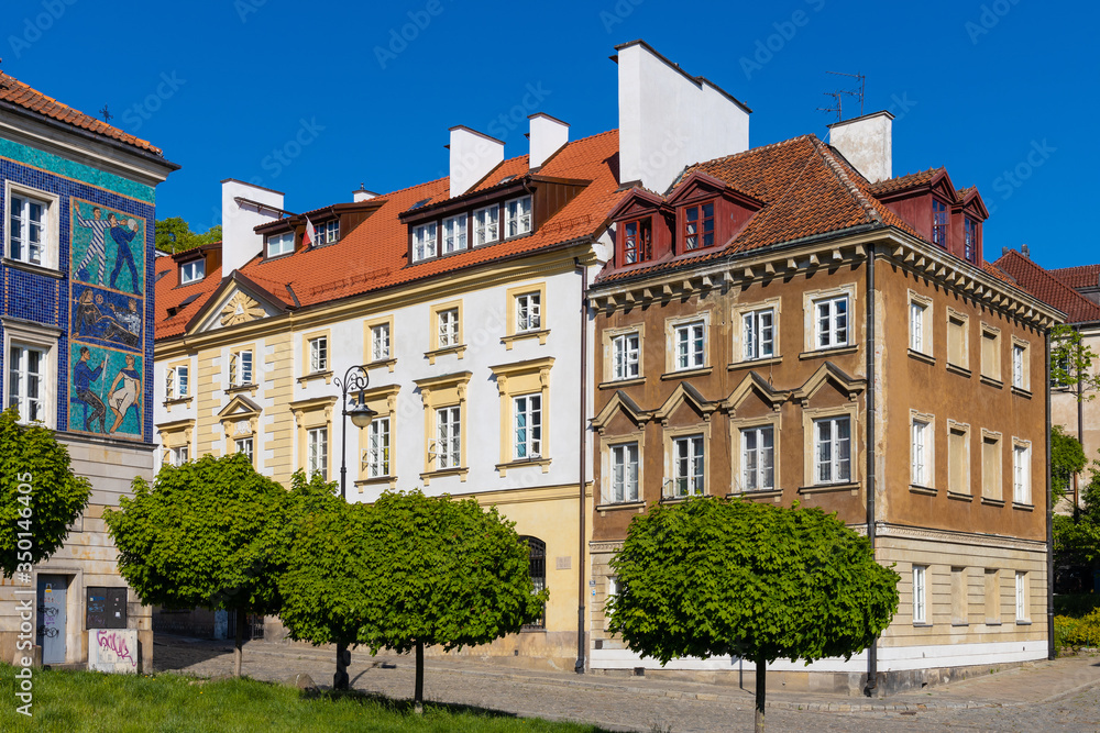 Panoramic view of historic, richly decorated colorful tenement houses at Bugaj, Mostowa and Brzozowa streets of Starowka Old Town quarter in Warsaw, Poland