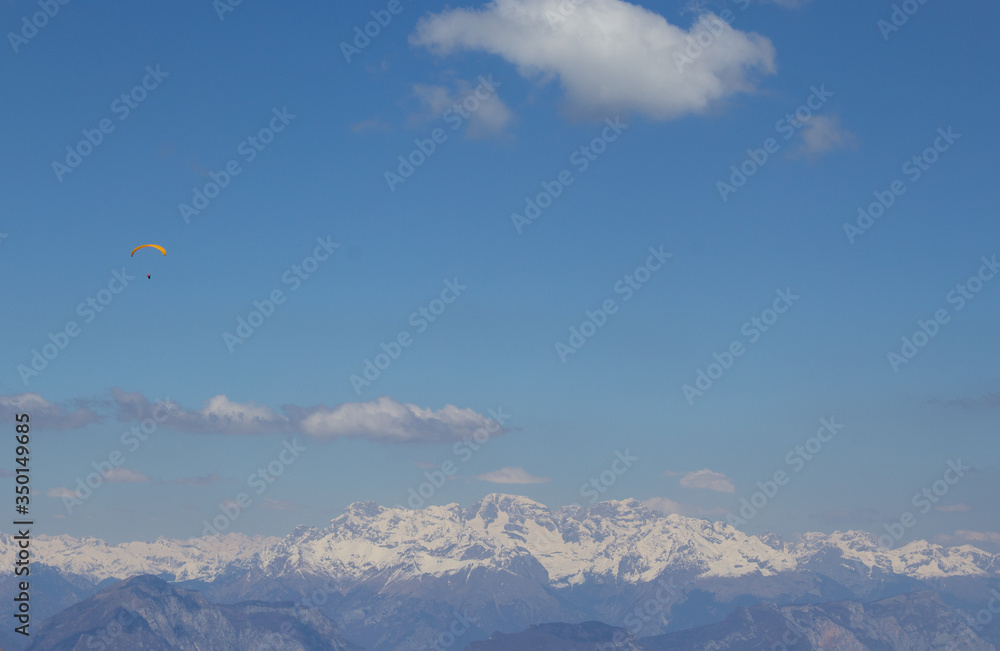 Paraglider field in the sky against the background of the Alpine mountains