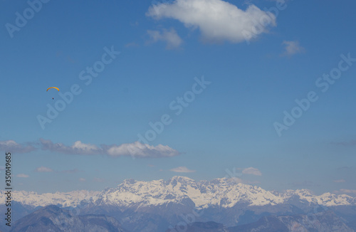 Paraglider field in the sky against the background of the Alpine mountains
