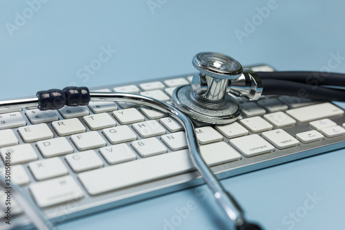 A stethoscope and a computer keyboard. Computer technology and medicine