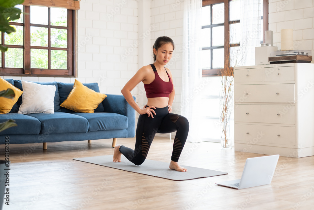 Young Asian healthy woman workout at home, exercise, fit, doing yoga, home fitness concept Young Asian healthy woman workout at home, exercise, fit, doing yoga, home fitness concept