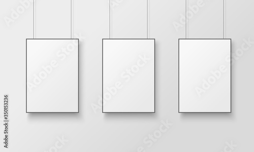White posters with black frame mockup.  Empty white A4 sized paper hanging on gray wall