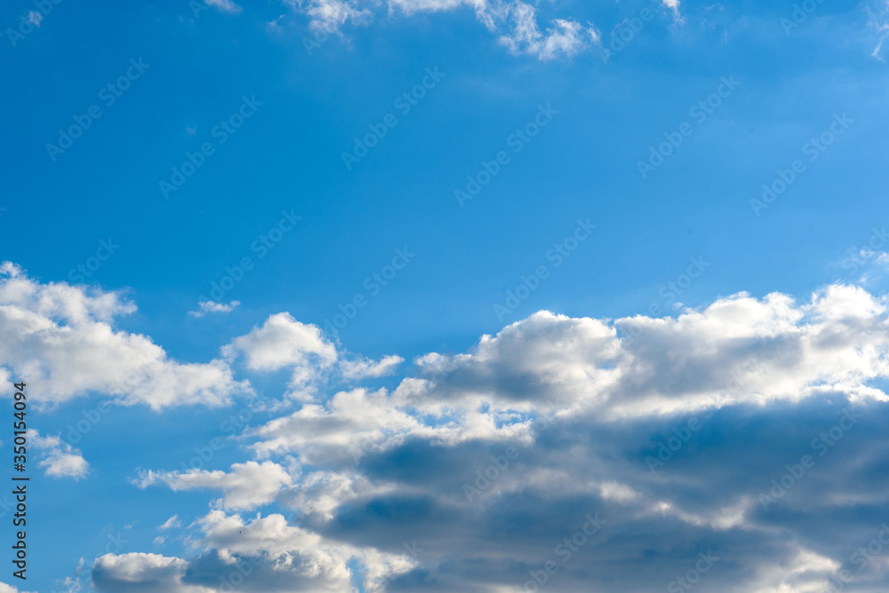 Beautiful clouds amid blue skies amid sunset on warm summer day Beautiful clouds amid blue skies amid sunset on warm summer day