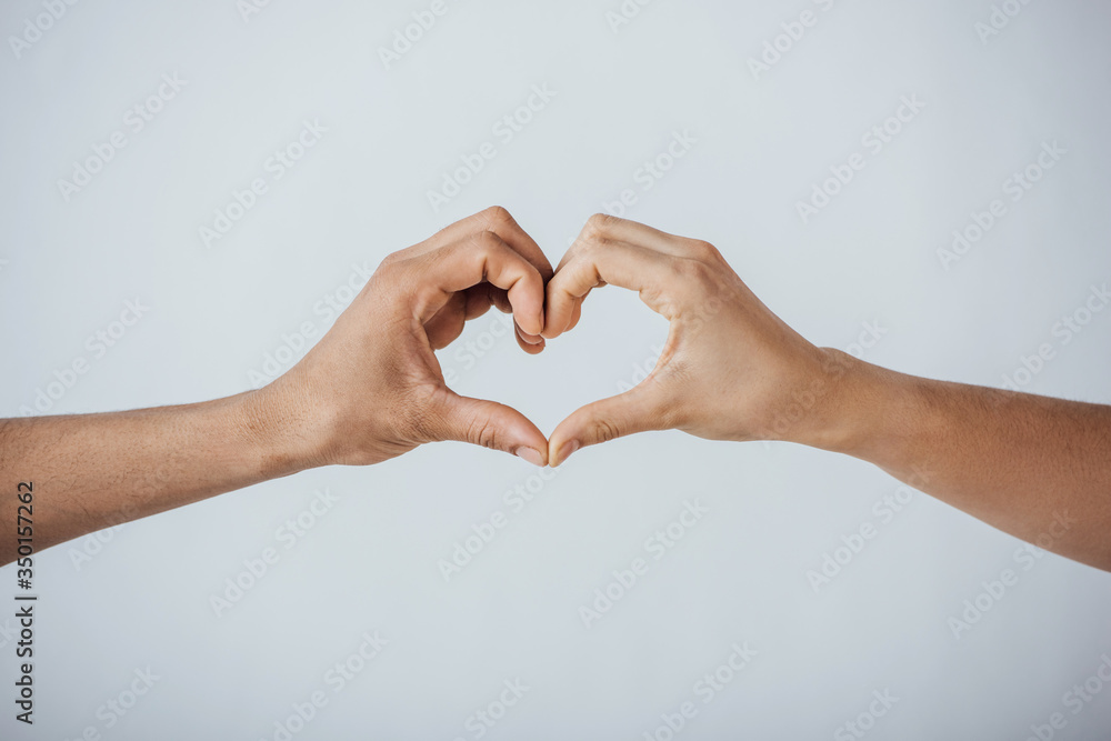 Cropped view of men gesturing love sign isolated on grey Cropped view of men gesturing love sign isolated on grey