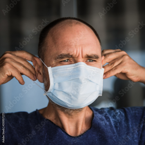 Man wearing facial disposable mask. Virus protection