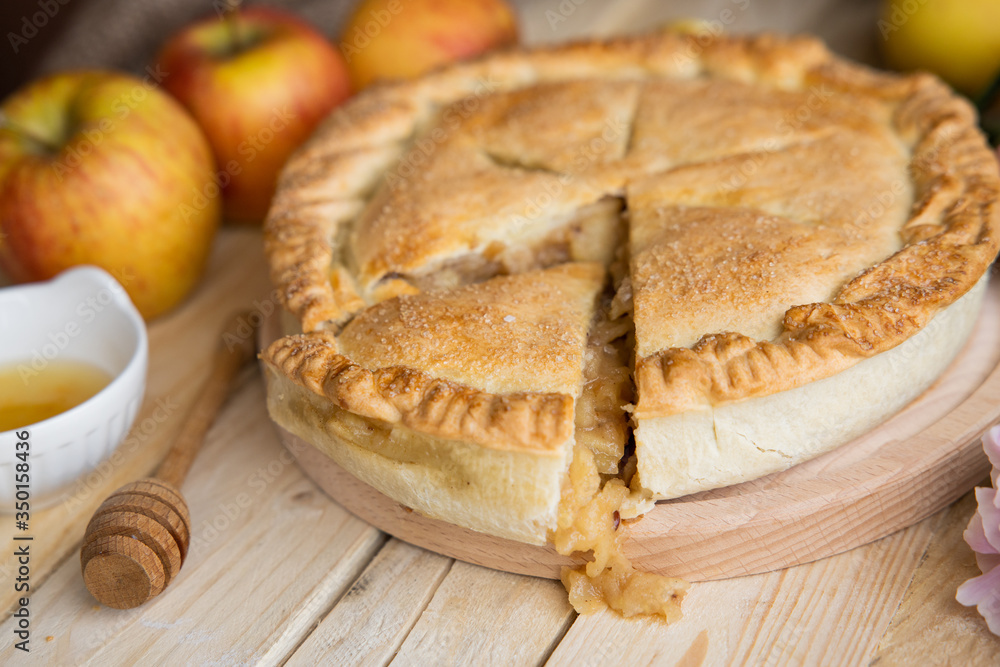 Apple pie on a wooden background, selective focus. Homemade American Pie from Organic Autumn Apples. Apple pie on a wooden background, selective focus. Homemade American Pie from Organic Autumn Apples.