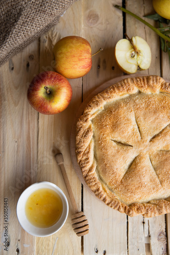 Fototapeta Naklejka Na Ścianę i Meble -  Apple pie on a wooden background, selective focus. Homemade American Pie from Organic Autumn Apples.