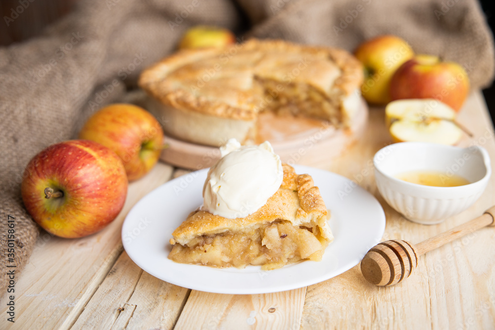 Slice of Apple Pie served on plate with vanilla ice cream. selective focus