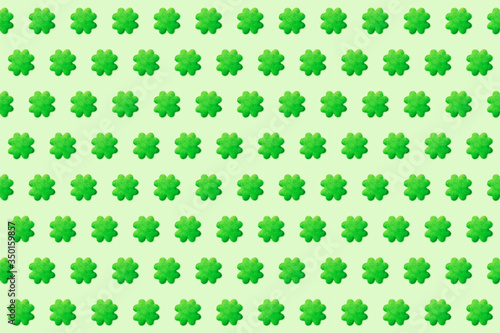 Green cookies in the shape of four leaf clover seamless pattern  St. Patrick s Day background for design or packaging  flat lay