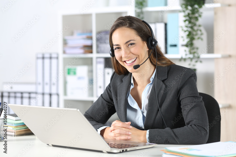 Happy telemarketer posing looking at camera at office Happy telemarketer posing looking at camera at office