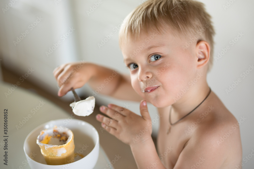 Little boy eats a spoon of ice cream Little boy eats a spoon of ice cream