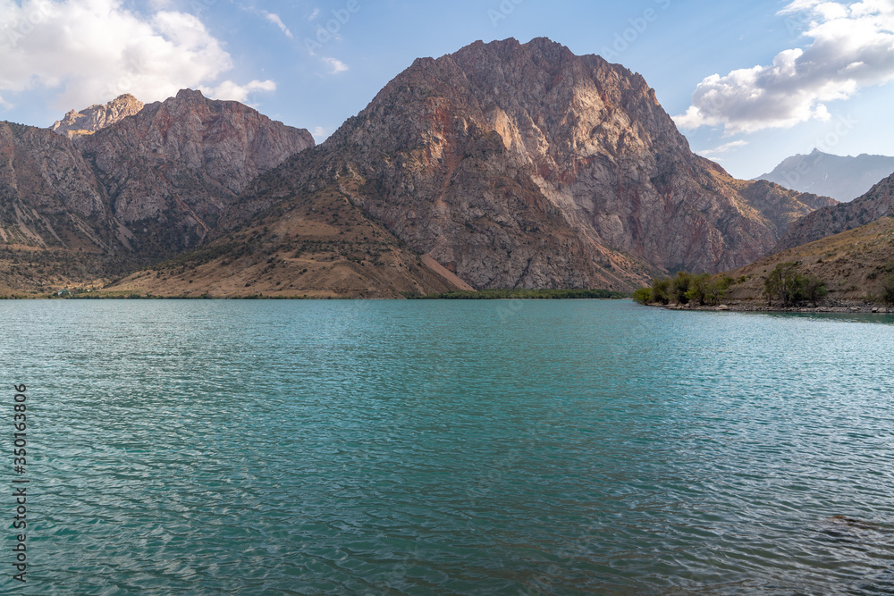 The scenic view of Iskanderkul lake and Fann mountains in Tajikistan