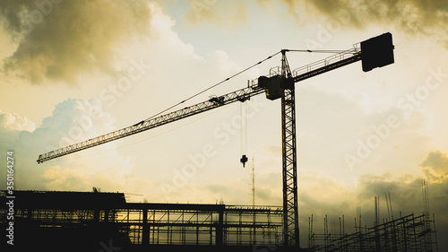 Silhouette of Tower Crane Construction at blue sky with copy space.
