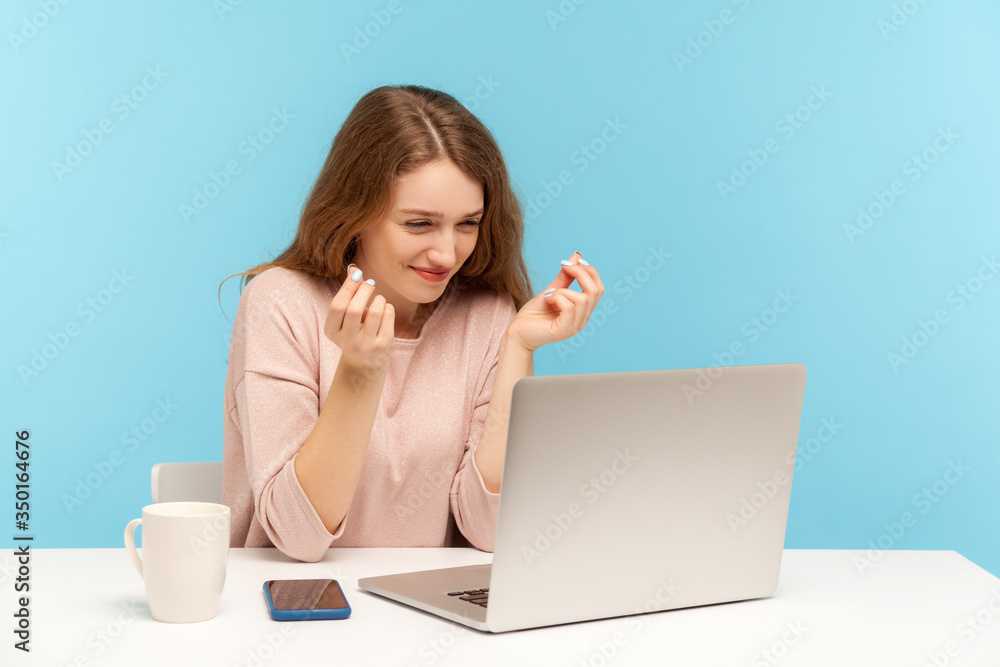 Need higher salary! Cheerful young woman employee showing money gesture to laptop screen, discussing payment on video call, planning business income. indoor studio shot isolated on blue background Need higher salary! Cheerful young woman employee showing money gesture to laptop screen, discussing payment on video call, planning business income. indoor studio shot isolated on blue background