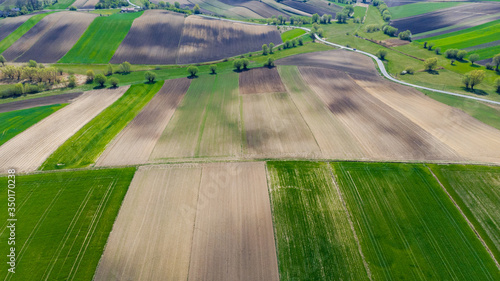 Ploughed or Plowed and Cultivated Fields in Farm. Geometric Fields Shapes. Aerial Drone View