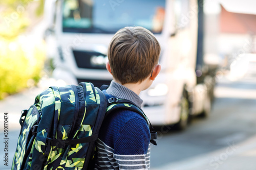 Картината върху платно Happy little kid boy with glasses and backpack or satchel