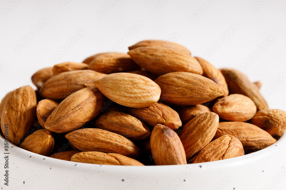 Fresh Almond nuts in a ceramics bowl Fresh Almond nuts in a ceramics bowl