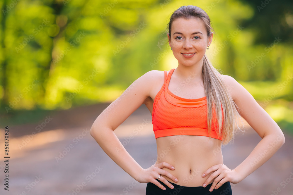 Beautiful happy girl in a park. Sports girl in a sportswear. Gir Beautiful happy girl in a park. Sports girl in a sportswear. Gir