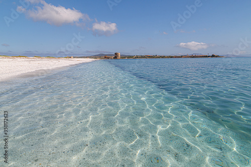 Fototapeta Naklejka Na Ścianę i Meble -  White pebble beach Spiaggia le Saline with crystal clear water in Stintino, Sardinia, Italy.