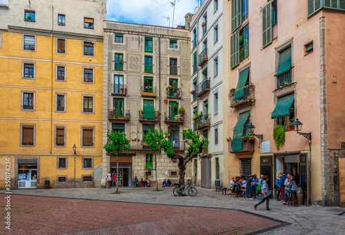 Canvas Print Cozy street with tables of bar in Barcelona, Catalonia, Spain
