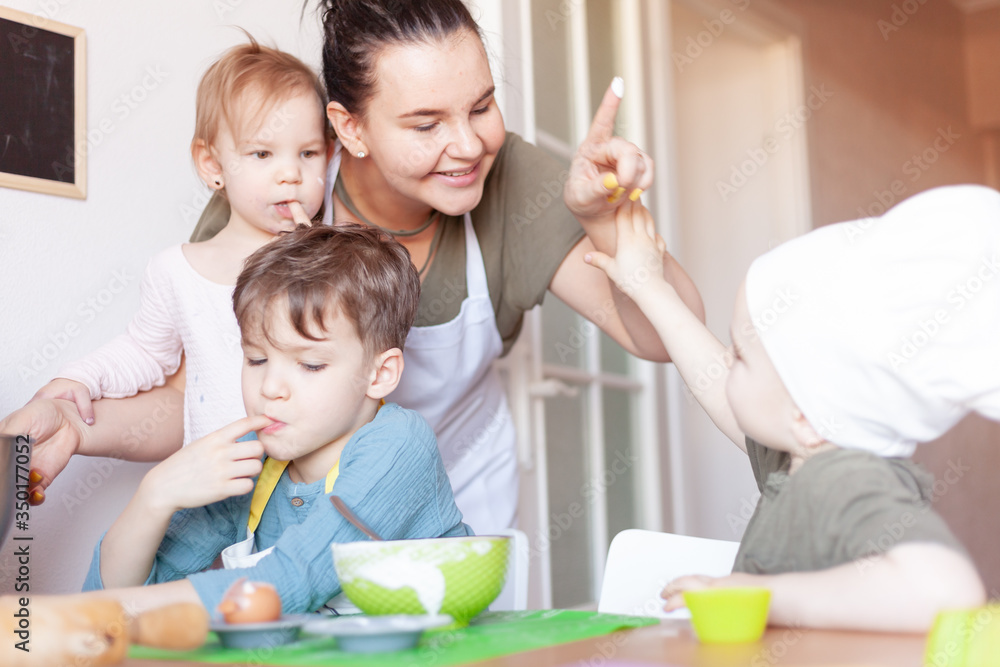 happy mom prepares a pie with children, entertains children on maternity happy mom prepares a pie with children, entertains children on maternity