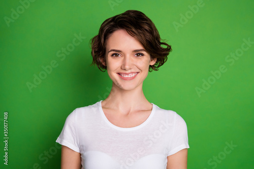 Closeup photo of cute attractive cheerful lady good mood beaming smile perfect groomed wavy bobbed hairdo wear casual white t-shirt isolated bright green color background