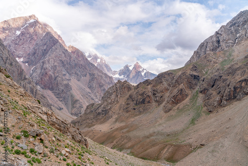 The beautiful view of blue sky and snow mountain summit near to Zmeya peak in Fann mountains in Tajikistan photo