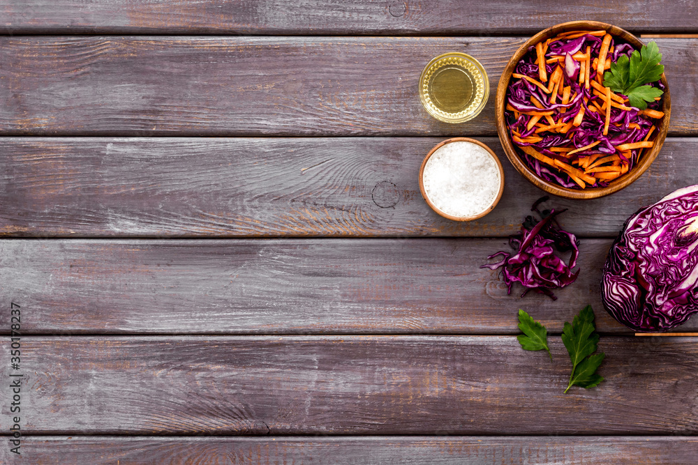 Healthy vegan salad with red cabbage on wooden kitchen table top view copy space