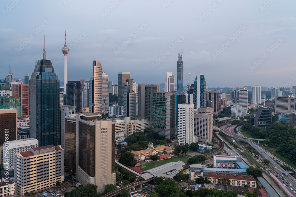Obraz premium Panoramic view of Kuala Lumpur skyline at sunset. City center of capital of Malaysia. Contemporary buildings exterior with glass.