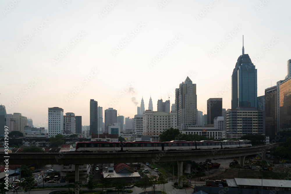 Obraz premium Panoramic view of Kuala Lumpur skyline at sunset. City center of capital of Malaysia. Contemporary buildings exterior with glass.