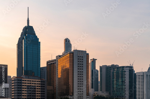 Panoramic view of Kuala Lumpur skyline at sunset. City center of capital of Malaysia. Contemporary buildings exterior with glass.