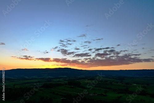 Aerial view of sunset landscape in the forest. Rural life scene. Great landscape.
