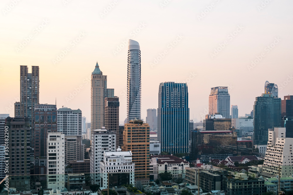 Panoramic view of Bangkok skyline at sunset. Modern city center of capital of Thailand. Contemporary buildings exterior with glass.