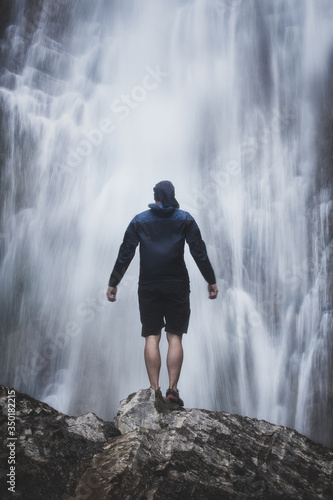 Man in front of an awesome waterfall, spanish pyrenees