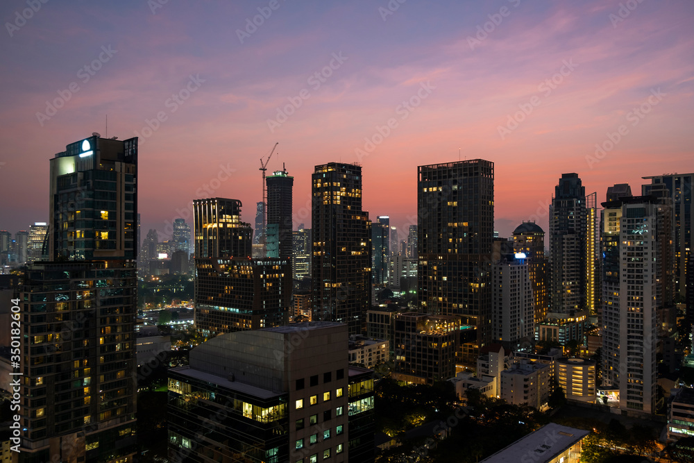 Fototapeta premium Panoramic view of Bangkok skyline at sunset. Modern city center of capital of Thailand. Contemporary buildings exterior with glass.