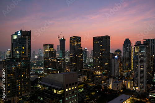 Panoramic view of Bangkok skyline at sunset. Modern city center of capital of Thailand. Contemporary buildings exterior with glass.